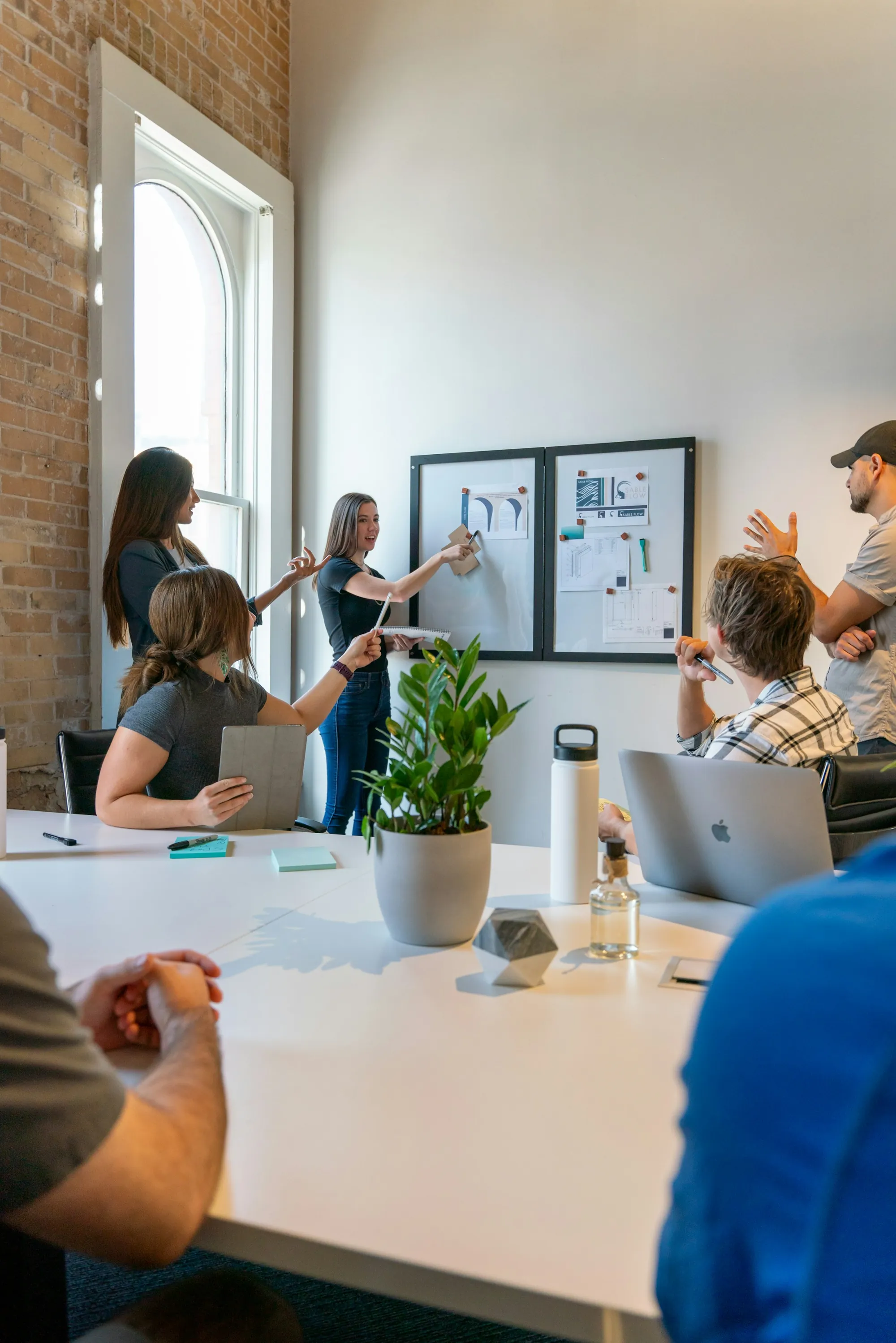 Group working together around a white table in a bright room