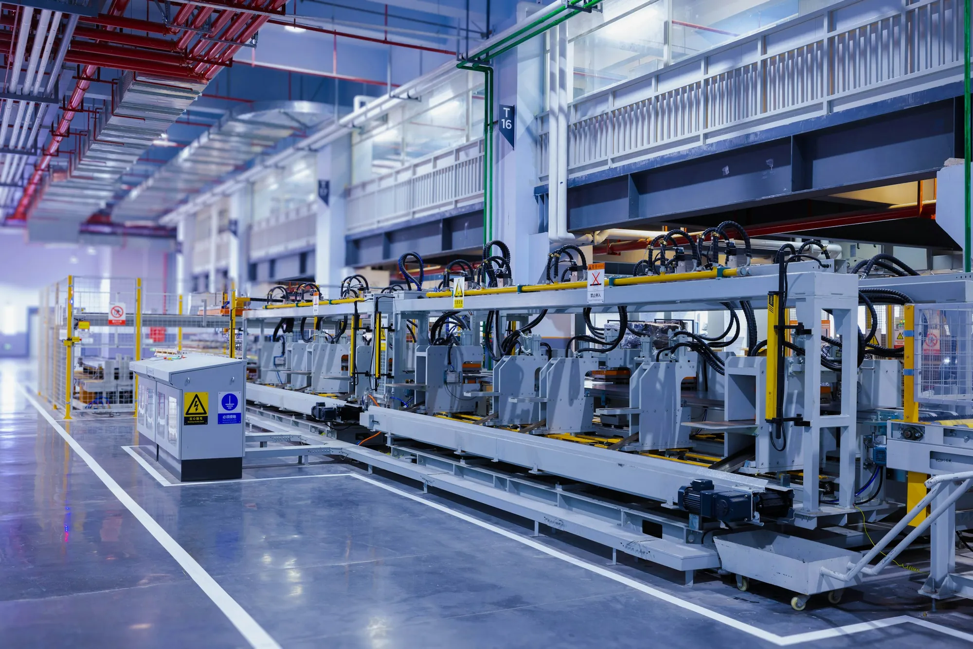 Large automated industrial machinery inside a bright plant hall